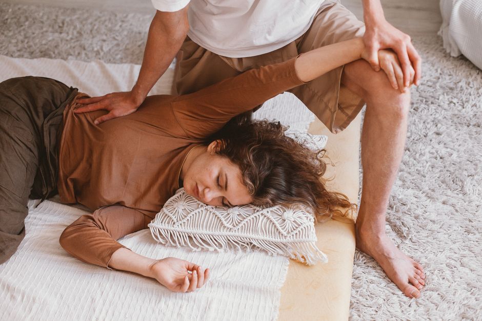 Relaxing indoor massage session capturing warmth and comfort with a focus on therapeutic techniques