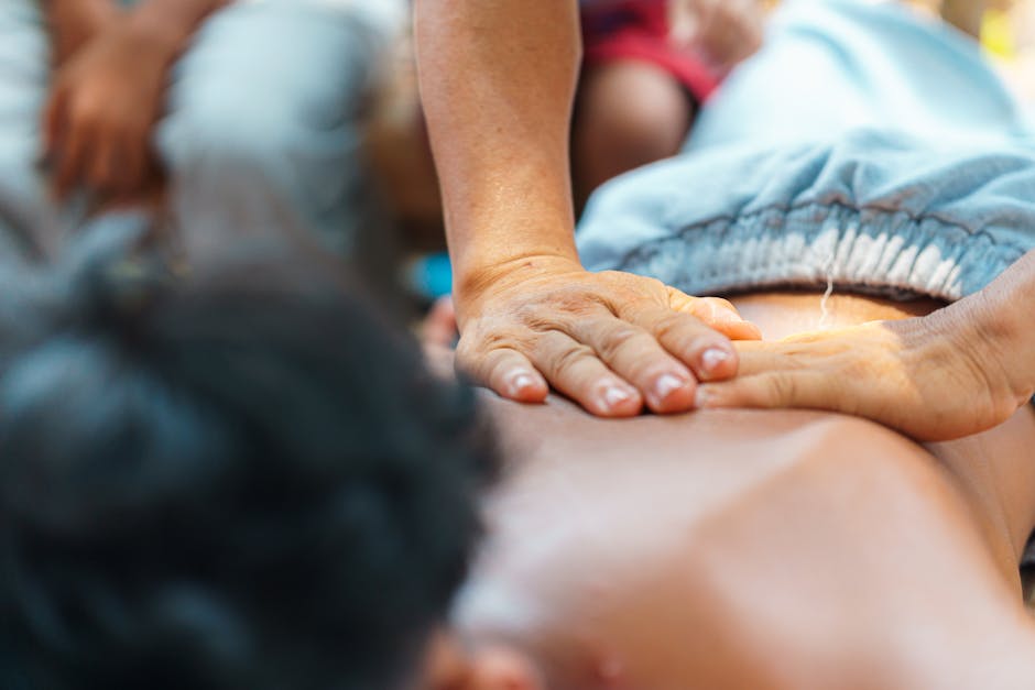 Close-up of a relaxing back massage being given outdoors, capturing the soothing atmosphere